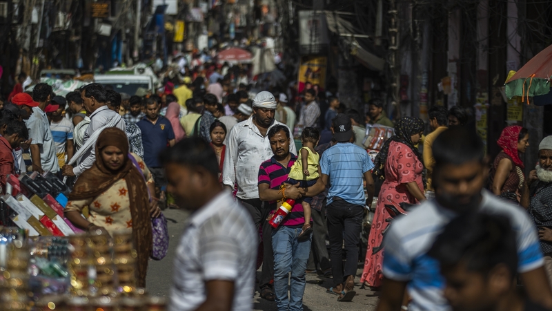 People walk through the Sadar Bazaar in New Delhi, India