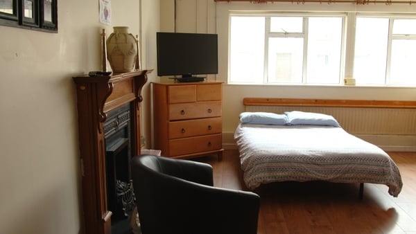 A camping bed set up in the living room of McGwire House in Waterford city