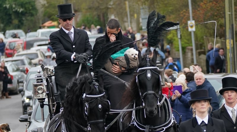 Husband of Paul O'Grady Andre Portasio (right) rides with the funeral cortege as it travels through the village of Aldington, Kent, ahead of his funeral at St Rumwold's Church