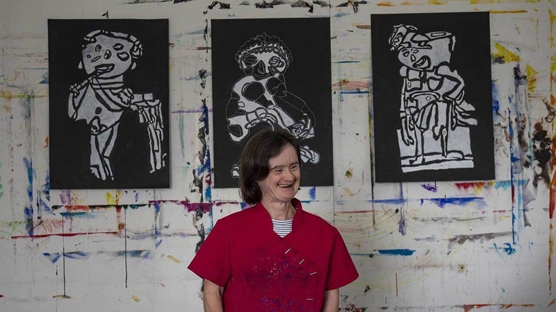 Artist Ailbhe Barrett with some of her works