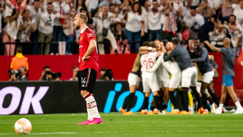 Christian Eriksen casts a dejected figure as Sevilla celebrate their victory at full-time at Ramon Sanchez-Pizjuan Stadium