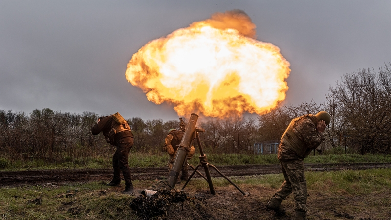 Ukrainian soldiers close to the frontline firing a mortar in the direction of Bakhmut