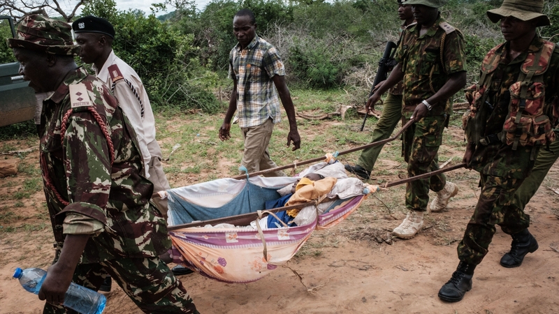 Security personnel carry a rescued young person from the forest in Shakahola, outside the coastal town of Malind