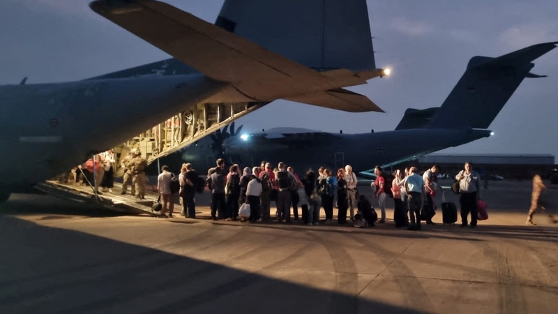 Italian citizens boarding an Italian Air Force C130 aircraft during their evacuation from Khartoum