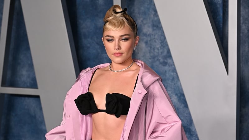 The British actor poses with a hot pink bag for the new campaign.