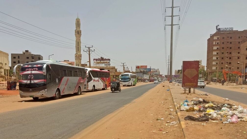 Buses parked along a deserted street as people flee the southern part of Khartoum amid ongoing street battles