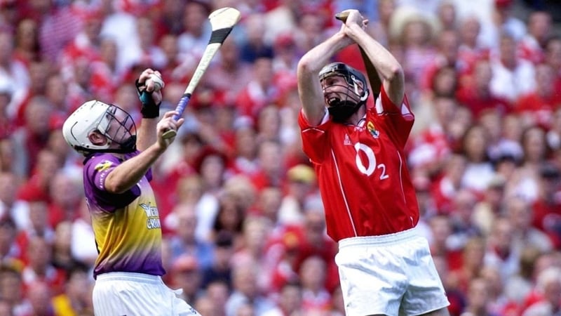 Spot the logo: Wexford's Paul Codd catches the sliothar ahead of Cork's Pat Mulcahy on his way to goal in the 2003 All-Ireland hurling semi-final