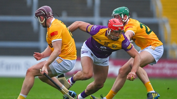 Lee Chin tries to break clear of Eoghan Campbell (l) and Paul Boyle