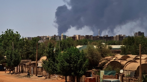 Smoke billows over residential buildings in Khartoum as deadly clashes between rival generals' forces have entered their third week