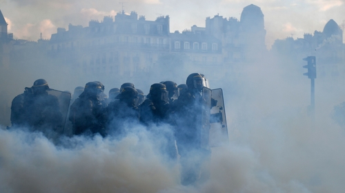 French Republican Security Corps police officers surrounded by tear gas during yesterday's rallies