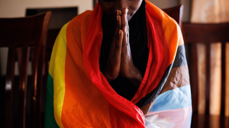 A member of the LGBTQ community prays during an evangelical church service in Uganda