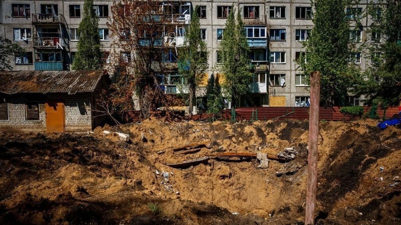 A damaged residential building and crater after missile strikes in Chasiv Yar, near the frontline city of Bakhmut
