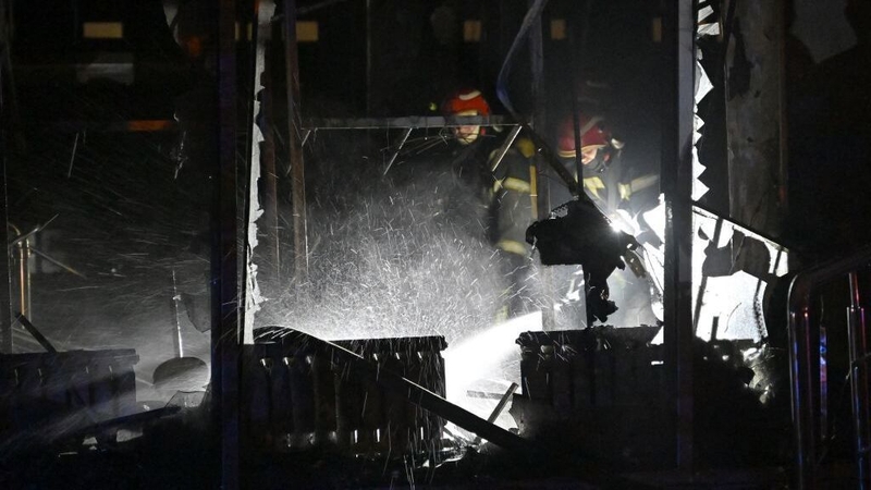 Firefighters put out a blaze in a Kyiv building damaged by drone fragments