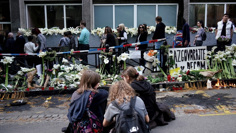 People queue to sign the book of condolences outside the Vladislav Ribnikar elementary school in the capital Belgrade