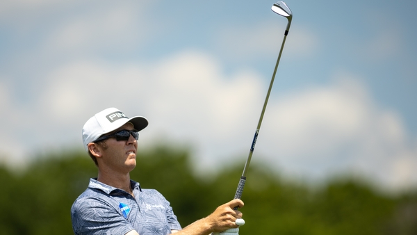 Power watches his tee shot fall on the 17th hole during the third round