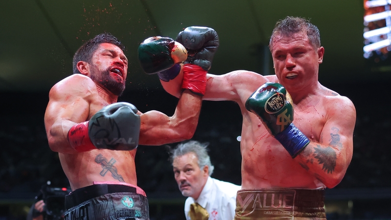 Canelo Alvarez punches John Ryder (l) during the bout in Guadalajara