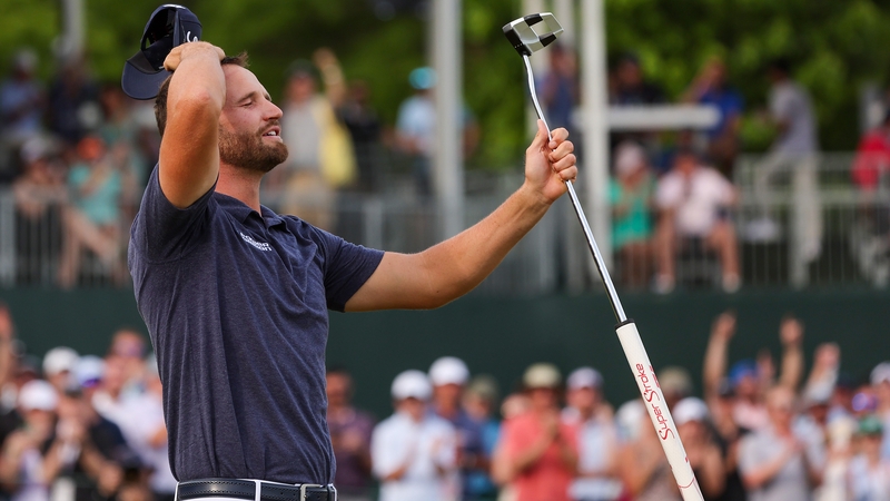 Wyndham Clark celebrates winning the Wells Fargo Championship on the 18th green at Quail Hollow