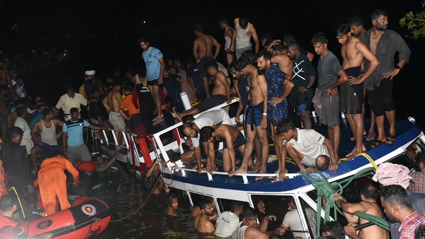 People carry out a rescue operation at the site of the boat accident in Tanur, in Malappuram district of India's Kerala state