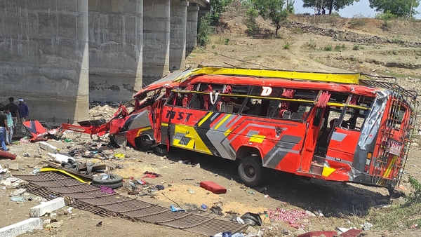 Onlookers gather at the site of the bus crash in Khargone district of India's Madhya Pradesh state