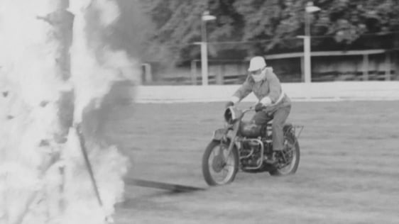A member of the Cavalry Corps rides a motorcycle through a wall of fire at the military mini-tattoo…