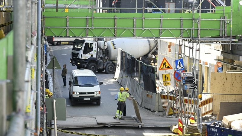 Labourers work at the site of the accident