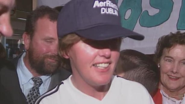 Josephine Kieran, a smiling woman wearing a blue baseball cap