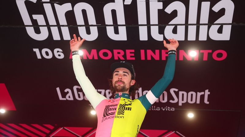 Ben Healy celebrates on the podium