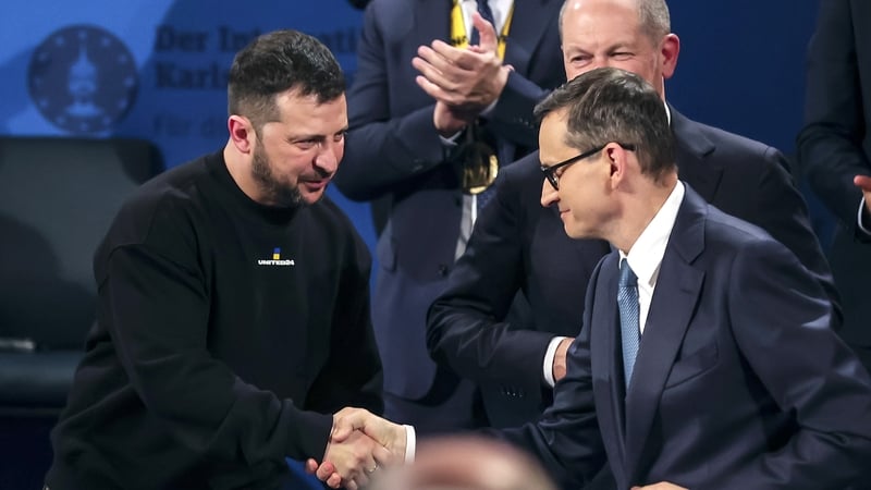 Ukrainian President Volodymyr Zelensky (L) and Polish Prime Minister Mateusz Morawiecki shake hands after the Charlemagne Prize (Karlspreis) ceremony