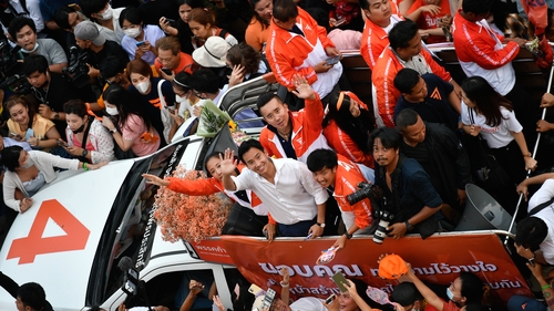 Move Forward party leader and prime minister candidate Pita Limjaroenrat waves to supporters as they celebrate the party's election results