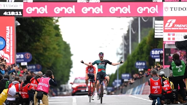 Nico Denz celebrates at the finish line to take stage 12 ahead of Toms Skujins