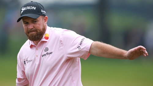 Lowry watches his par putt miss on the 18th green