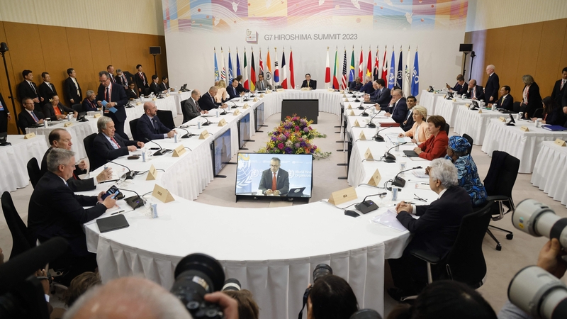 Japan's Prime Minister Fumio Kishida (C) hosts a working session as part of the G7 summit in Hiroshima
