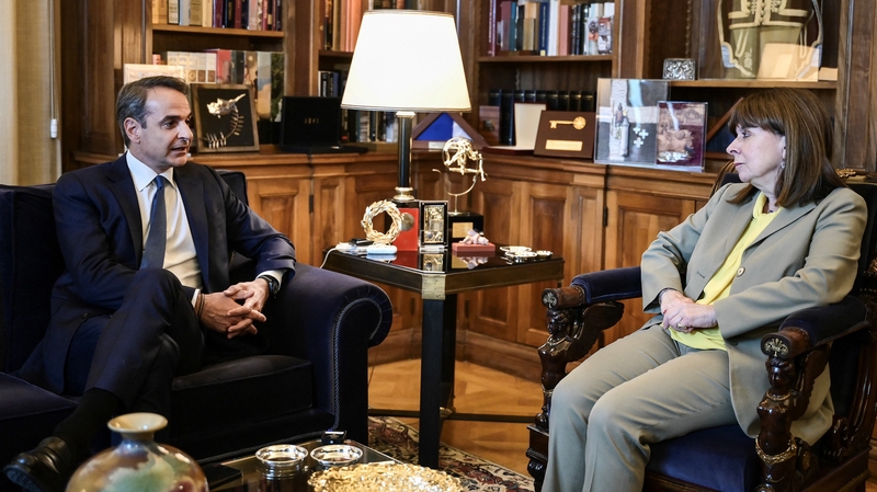 Greek Prime Minister Kyriakos Mitsotakis speaks with Greek President Katerina Sakellaropoulou ahead of their meeting at the Presidential Palace in Athens