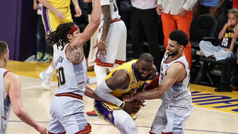 Los Angeles Lakers forward LeBron James (6) gets tied up on his last shot of the game by Denver Nuggets guard Jamal Murray (27)