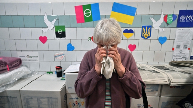 A displaced Bakhmut resident cries as she visits a support center in Kyiv this week