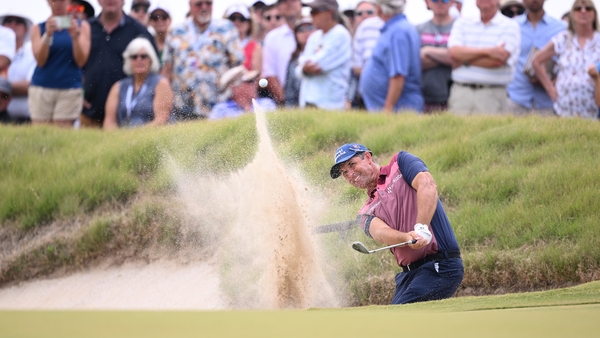 Padraig Harrington plays out of the bunker on the 18th hole