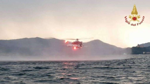 The boat tipped over yesterday off Lisanza, at the southern end of the lake in northern Italy (Image: Vigili del Fuoco)