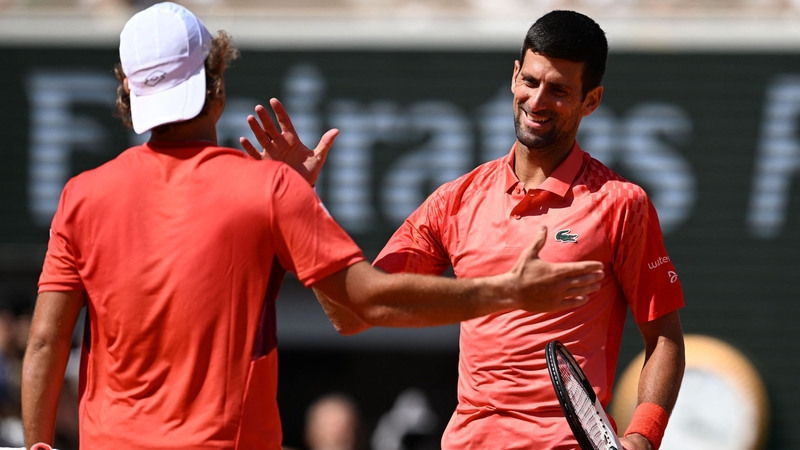 Novak Djokovic shakes hands with Aleksandar Kovacevic after the game