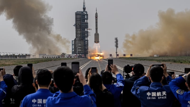 Members from China's Manned Space Agency and visitors watch as the Shenzhou-16 spacecraft takes off in Jiuquan, China