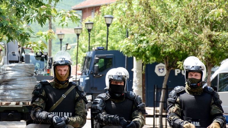 The NATO soldiers wearing full riot gear guarding the municipal building in Zvecan, northern Kosovo