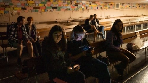 People taking cover in a shelter during an air raid in Kyiv