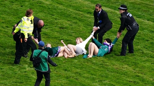 Police remove protesters from the track on Epsom Derby day