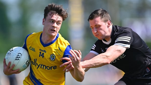 Ben O'Carroll of Roscommon in action against Eddie McGuinness