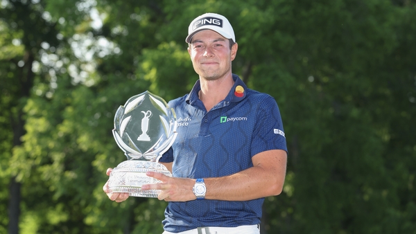 Hovland poses for a photo with the trophy after sealing victory