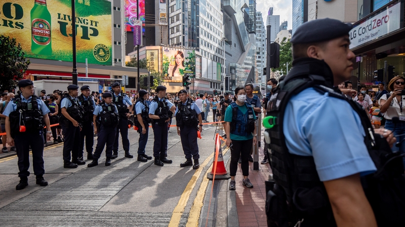 Police officers stand guard near Victoria Park, the traditional site of the annual Tiananmen candlelight vigil, in Hong Kong