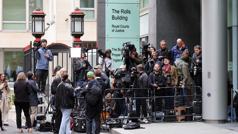 Members of the press wait for the Mirror Group Phone hacking trial at High Court in London