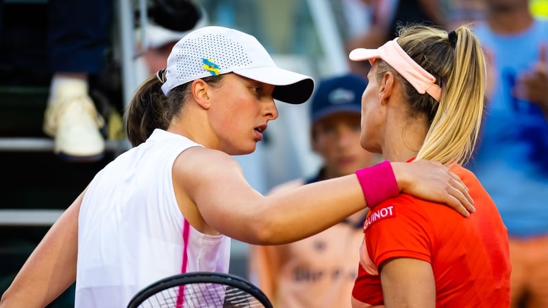 Iga Swiatek embraces Lesia Tsurenko after the Ukrainian retired due to illness