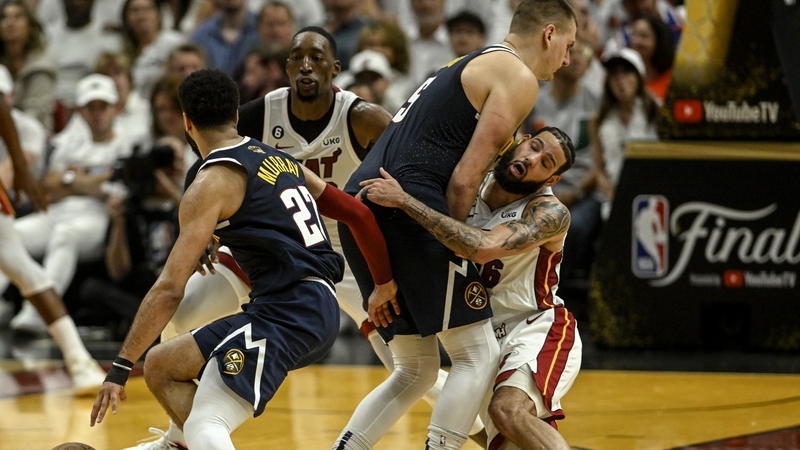 Nikola Jokic (15) of the Denver Nuggets blows up Caleb Martin (16) of the Miami Heat as he sets a pick for Jamal Murray (27)