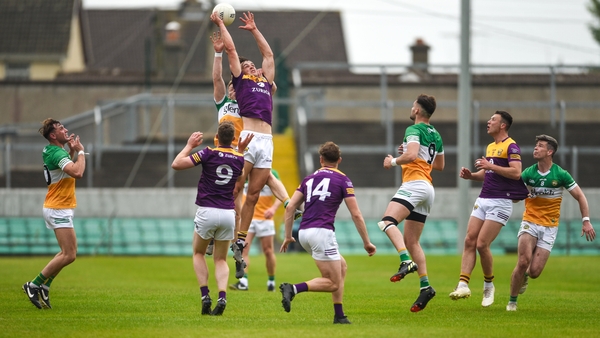 Liam Coleman springs to claim possession in the midfield tussle against Offaly