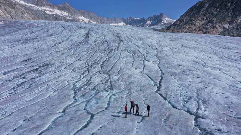 Scientists install remote monitoring devices in June 2022 for recording data related to the glacier's melting stand on the surface of the receding Rhone glacier near Gletsch, Switzerland.